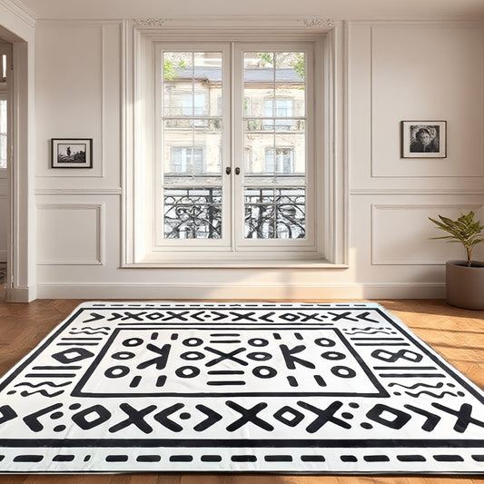 Geometric tribal-style rug with bold symbolic patterns laid in a bright, elegant living room setting.