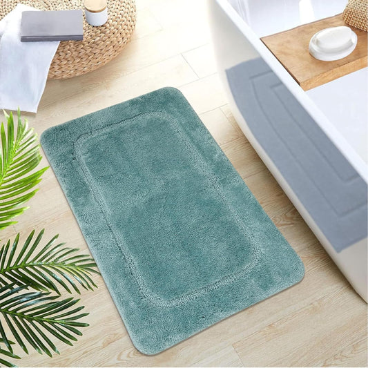 Turquoise shaggy bathroom rug with soft microfiber texture and simple rectangular border design, perfect for a cozy, spa-like feel.