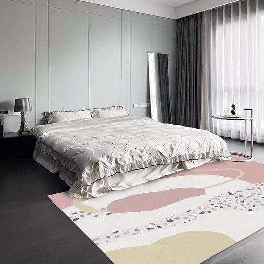 Abstract pink boho area rug with terrazzo pattern and modern organic shapes in cream, blush, and beige tones.