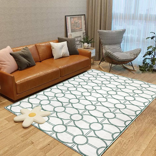 White summer rug with a modern green circular geometric pattern.