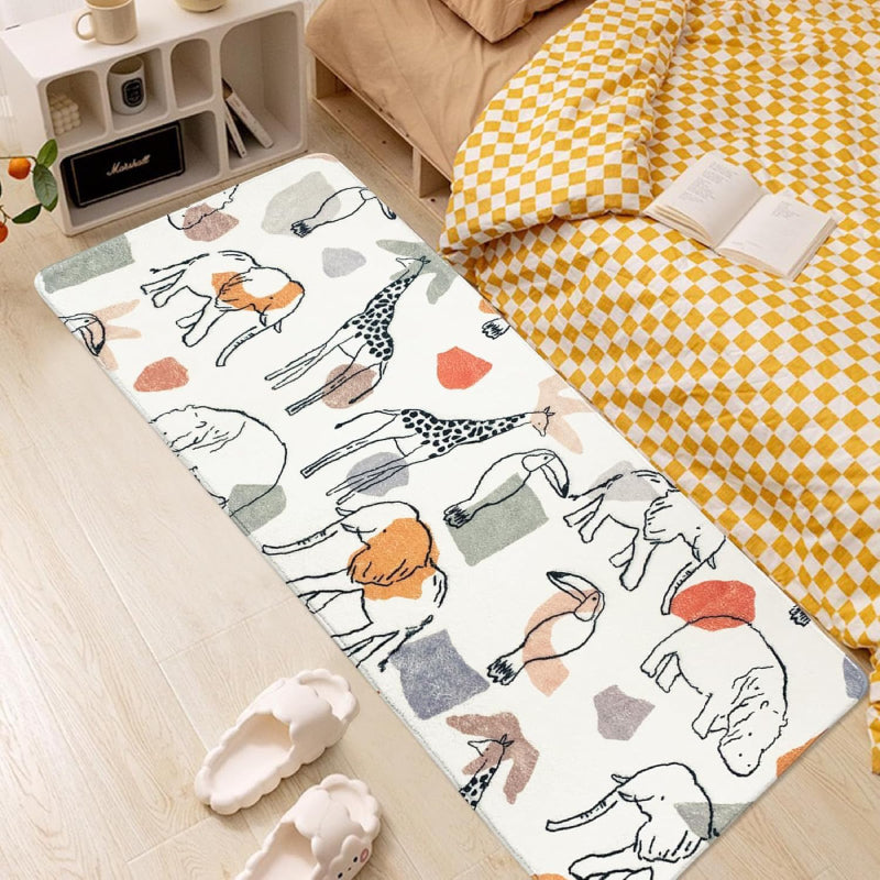 Children's bedroom with a soft rectangular rug featuring hand-drawn animals like giraffes, lions, elephants, and camels in neutral and pastel colors.