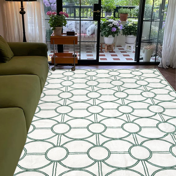 White summer rug with a modern green circular geometric pattern.