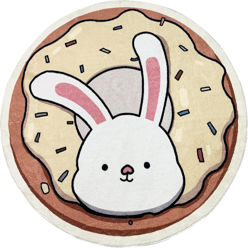 A round children's rug featuring a cute white bunny with pink ears popping out of a donut topped with cream-colored frosting and colorful sprinkles.