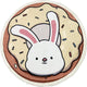 A round children's rug featuring a cute white bunny with pink ears popping out of a donut topped with cream-colored frosting and colorful sprinkles.
