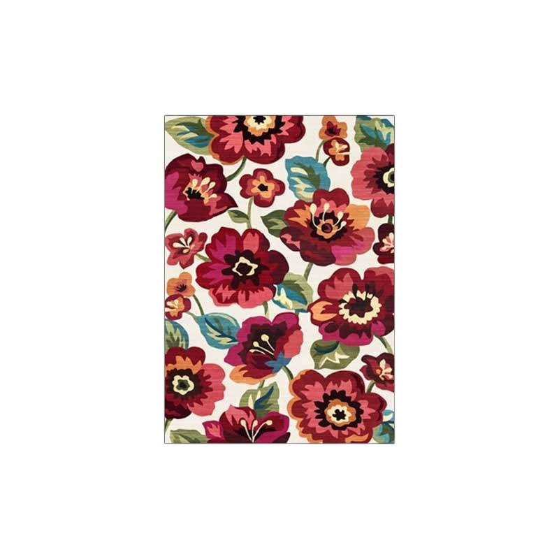 Colorful floral-patterned living room rug with vibrant red, pink, and orange flowers on a white background.