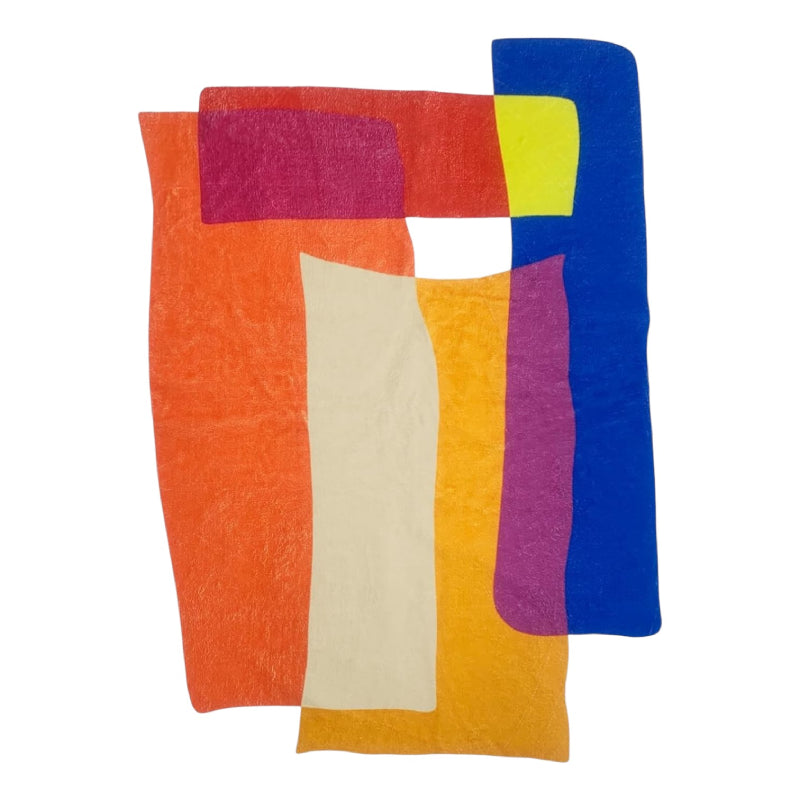 Abstract living room rug with overlapping geometric shapes in vibrant colors including orange, blue, yellow, magenta, and cream.
