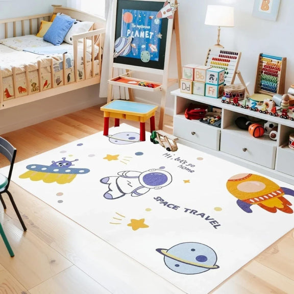 Kids rug with outer space theme featuring cartoon astronaut, rocket, UFO, planets, stars, and the phrases 'Hi, let's go home' and 'SPACE TRAVEL'.