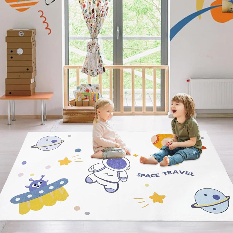 Kids rug with outer space theme featuring cartoon astronaut, rocket, UFO, planets, stars, and the phrases 'Hi, let's go home' and 'SPACE TRAVEL'.