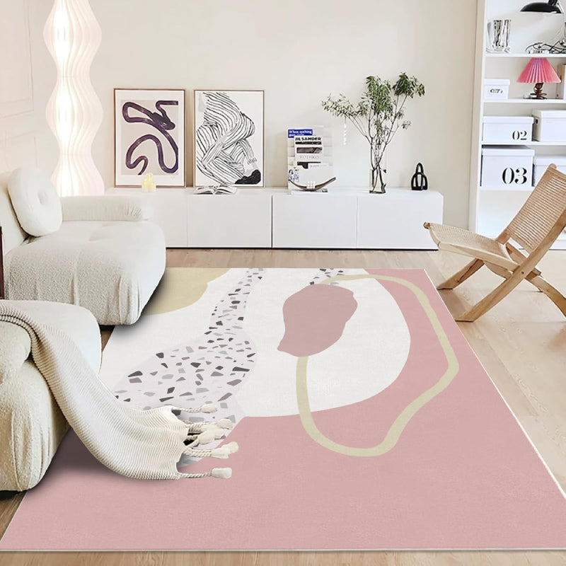 Abstract pink boho area rug with terrazzo pattern and modern organic shapes in cream, blush, and beige tones.