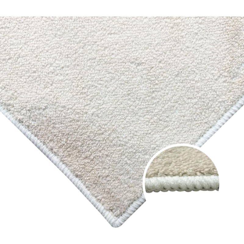 Abstract pink boho area rug with terrazzo pattern and modern organic shapes in cream, blush, and beige tones.