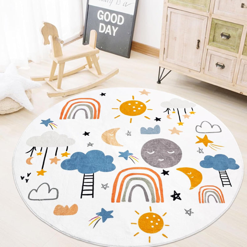 A round kids rug featuring colorful rainbows, smiling suns and moons, clouds, stars, and ladders on a white background. The playful design is ideal for a nursery or playroom.