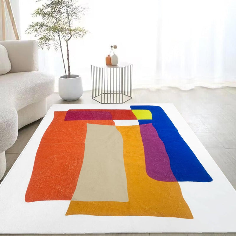 Abstract living room rug with overlapping geometric shapes in vibrant colors including orange, blue, yellow, magenta, and cream.