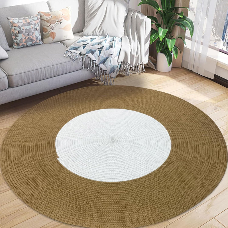 Round handmade braided rug with a white center and wide brown outer ring, made from cotton rope.