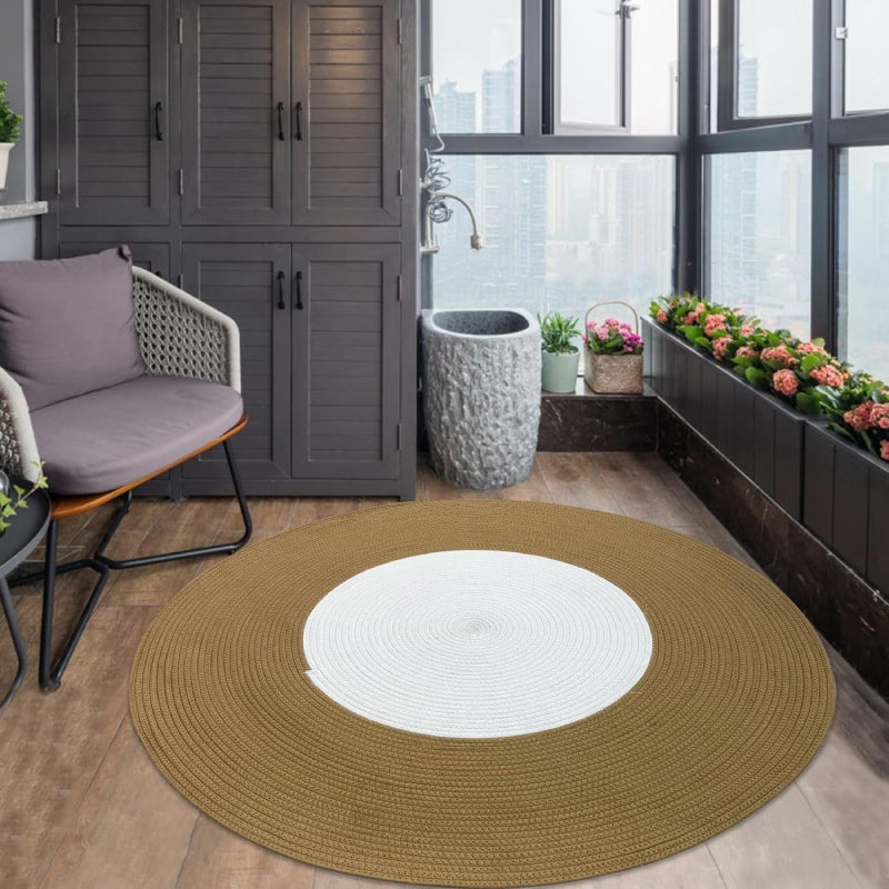 Round handmade braided rug with a white center and wide brown outer ring, made from cotton rope.