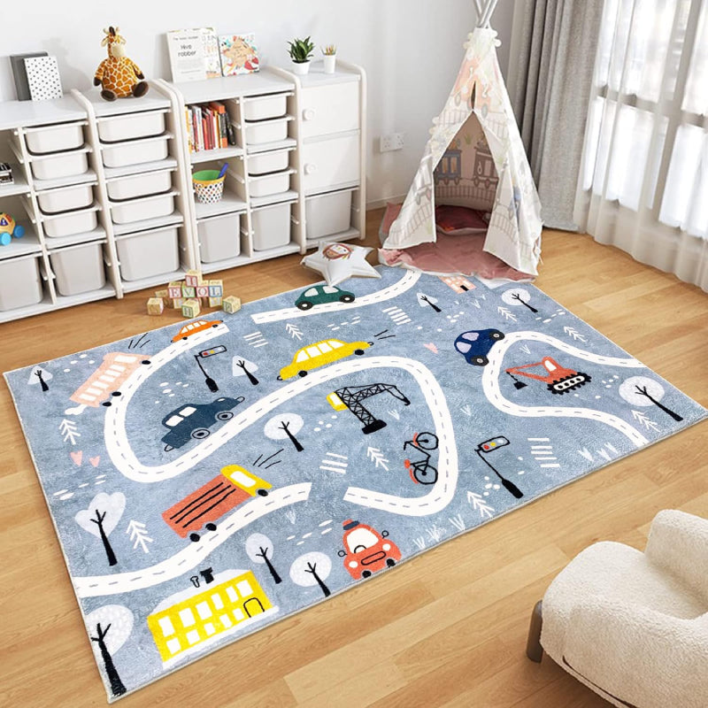 Rectangular kids rug measuring 59 inches by 39.3 inches, featuring a winding town road design with colorful cars, buses, traffic lights, trees, buildings, and construction vehicles on a blue background.