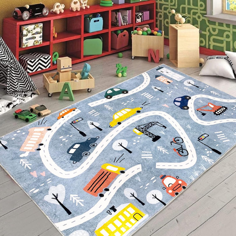 Rectangular kids rug measuring 59 inches by 39.3 inches, featuring a winding town road design with colorful cars, buses, traffic lights, trees, buildings, and construction vehicles on a blue background.