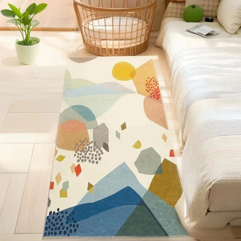 Kids rug with abstract colorful stone pattern in shades of blue, yellow, red, green, and beige on a cream background.