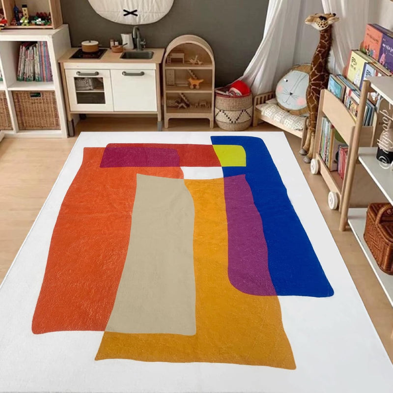 Abstract living room rug with overlapping geometric shapes in vibrant colors including orange, blue, yellow, magenta, and cream.