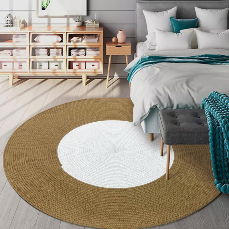Round handmade braided rug with a white center and wide brown outer ring, made from cotton rope.