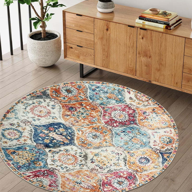 Round boho vintage area rug with a colorful patchwork of floral and medallion patterns in orange, blue, red, and cream tones.