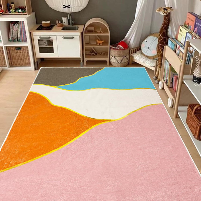 Colorful living room rug with a bright geometric pattern of intersecting triangles in blue, pink, orange, white, and brown, outlined with yellow lines and yellow circular nodes.