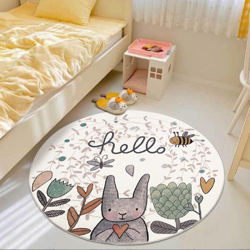 Round children's rug featuring a cute gray Easter bunny holding a heart, surrounded by flowers, a bee, a butterfly, and the word "hello" in playful script on a light background.