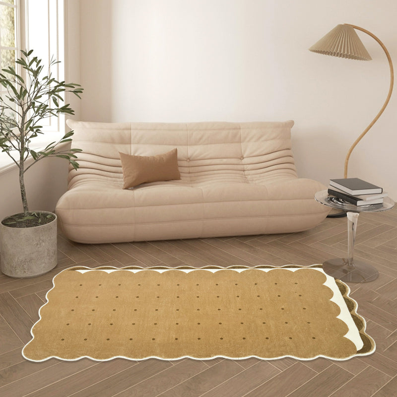 Kids area rug shaped like a biscuit with scalloped edges and dotted details, perfect for playful and cozy spaces.