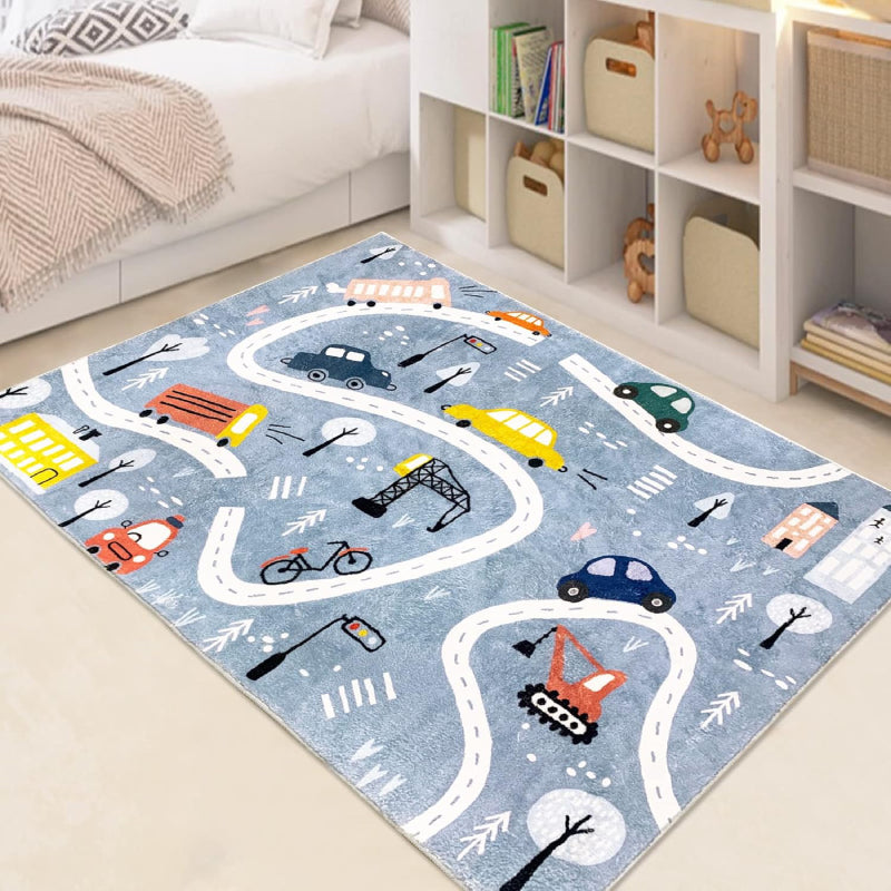 Rectangular kids rug measuring 59 inches by 39.3 inches, featuring a winding town road design with colorful cars, buses, traffic lights, trees, buildings, and construction vehicles on a blue background.