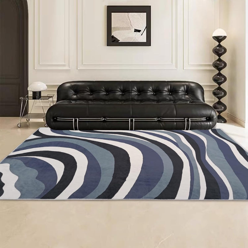 Laundry rug with abstract blue, black, and white wavy line pattern, modern design with a soft textured surface.