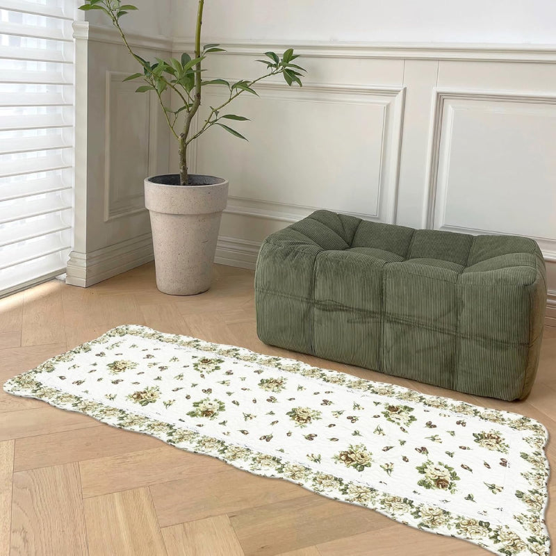 Rectangular living room rug with a white background, featuring a vintage yellow rose floral pattern and a scalloped floral border
