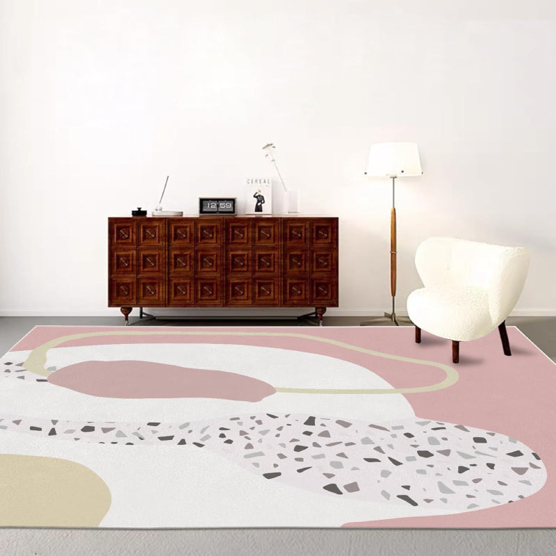 Abstract pink boho area rug with terrazzo pattern and modern organic shapes in cream, blush, and beige tones.