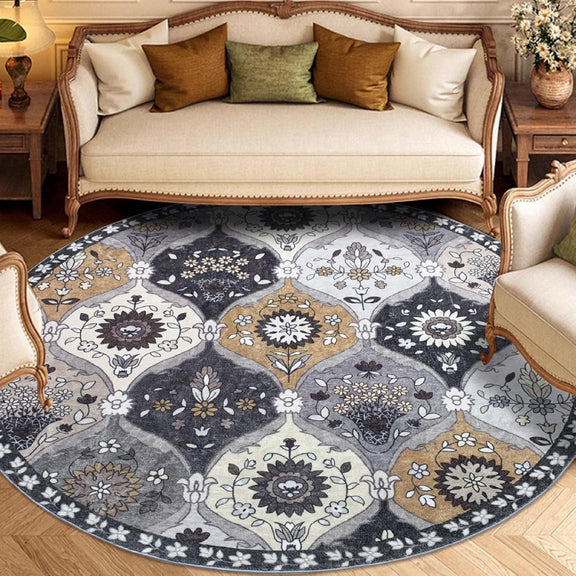 Round vintage floral rug with intricate medallion-style patterns in neutral tones of grey, ivory, and gold.