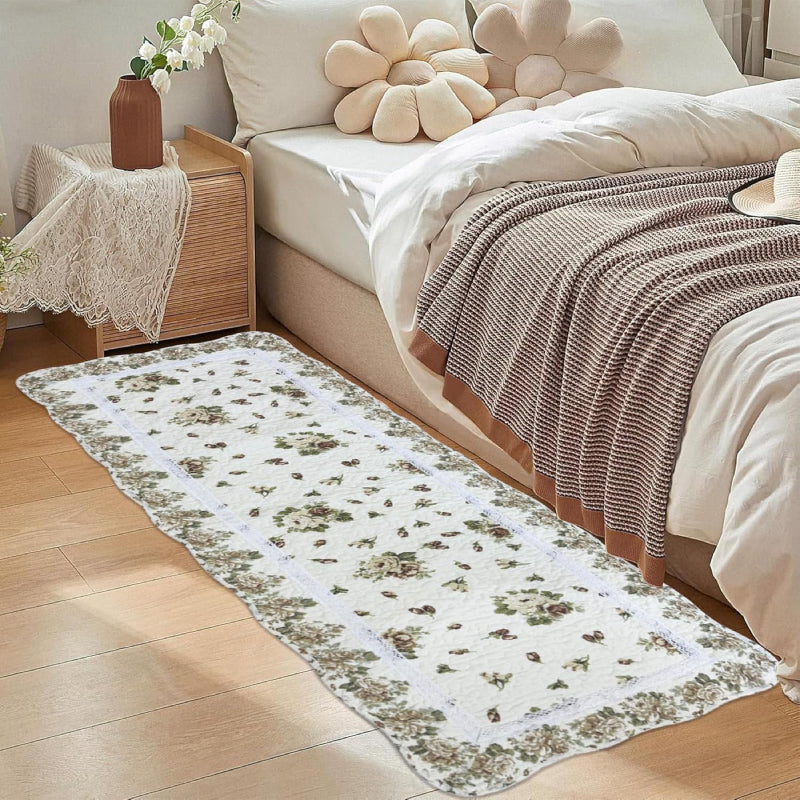 Rectangular living room rug with a white background, featuring a vintage yellow rose floral pattern and a scalloped floral border
