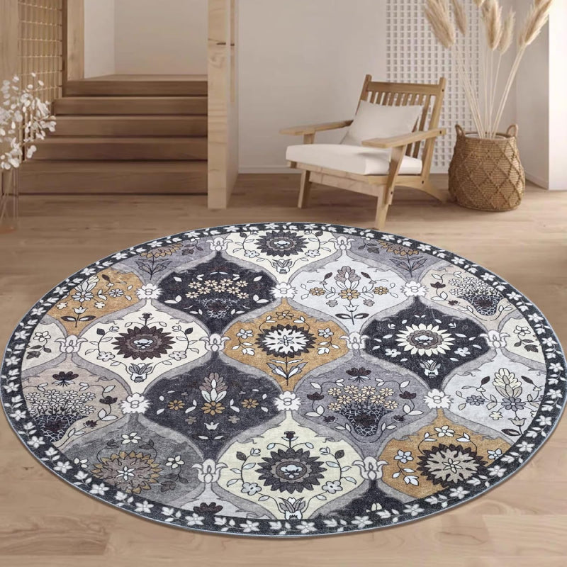Round vintage floral rug with intricate medallion-style patterns in neutral tones of grey, ivory, and gold.